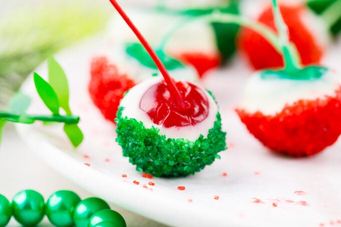 Homemade boozy Christmas drunken cherries dipped in white chocolate, red and green sanding sugar.