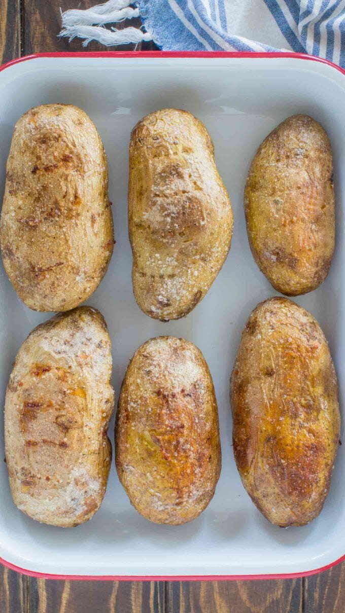 Simple oven baked potatoes with crispy skin on a baking dish