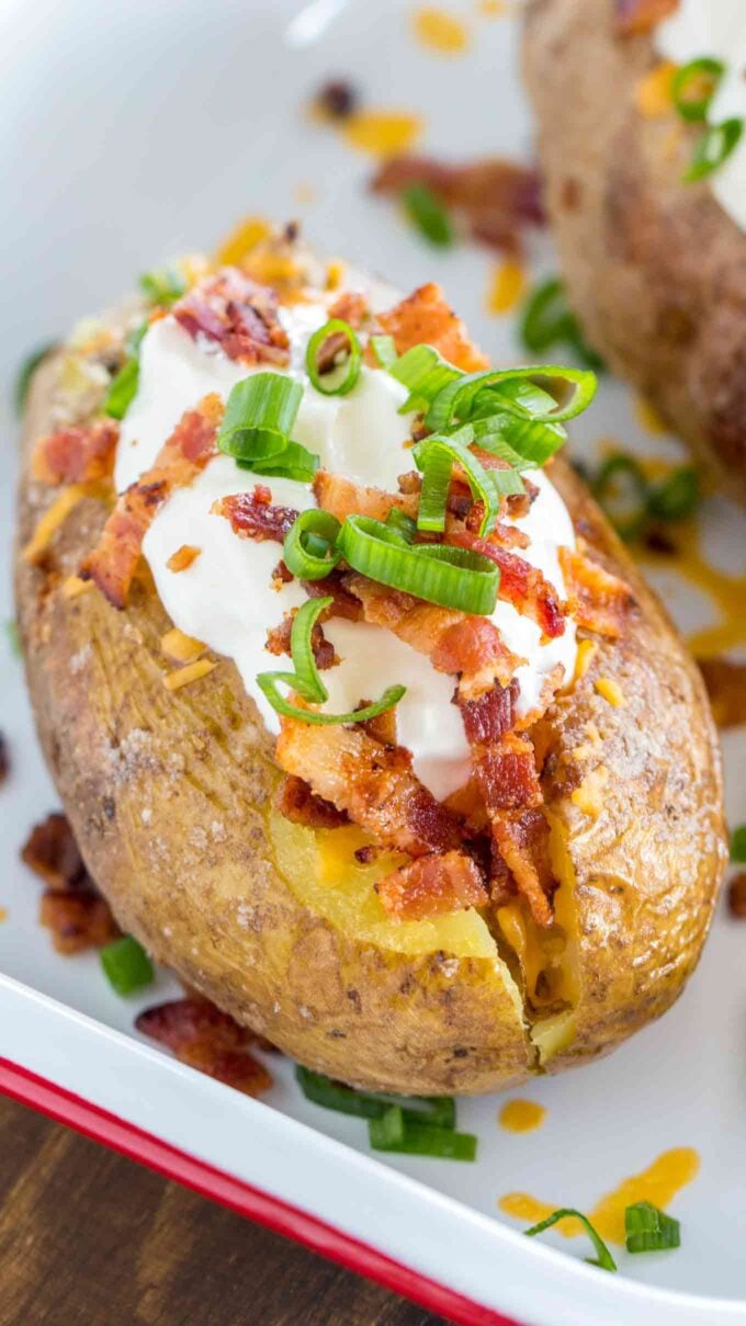 Oven baked potatoes topped with sour cream and bacon