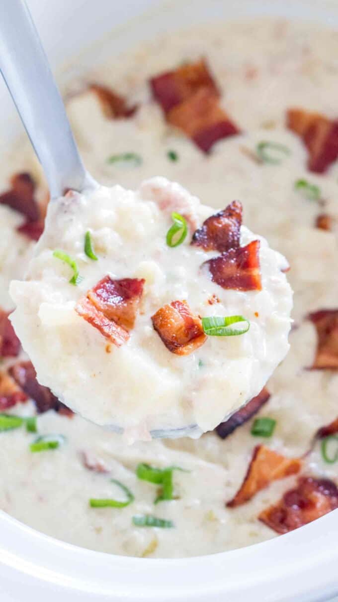 Slow cooker clam chowder topped with crispy bacon and chopped green onion