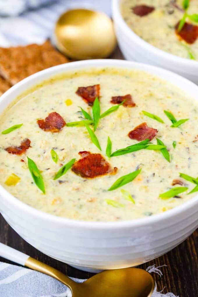 a bowl of crockpot clam chowder topped with crispy bacon