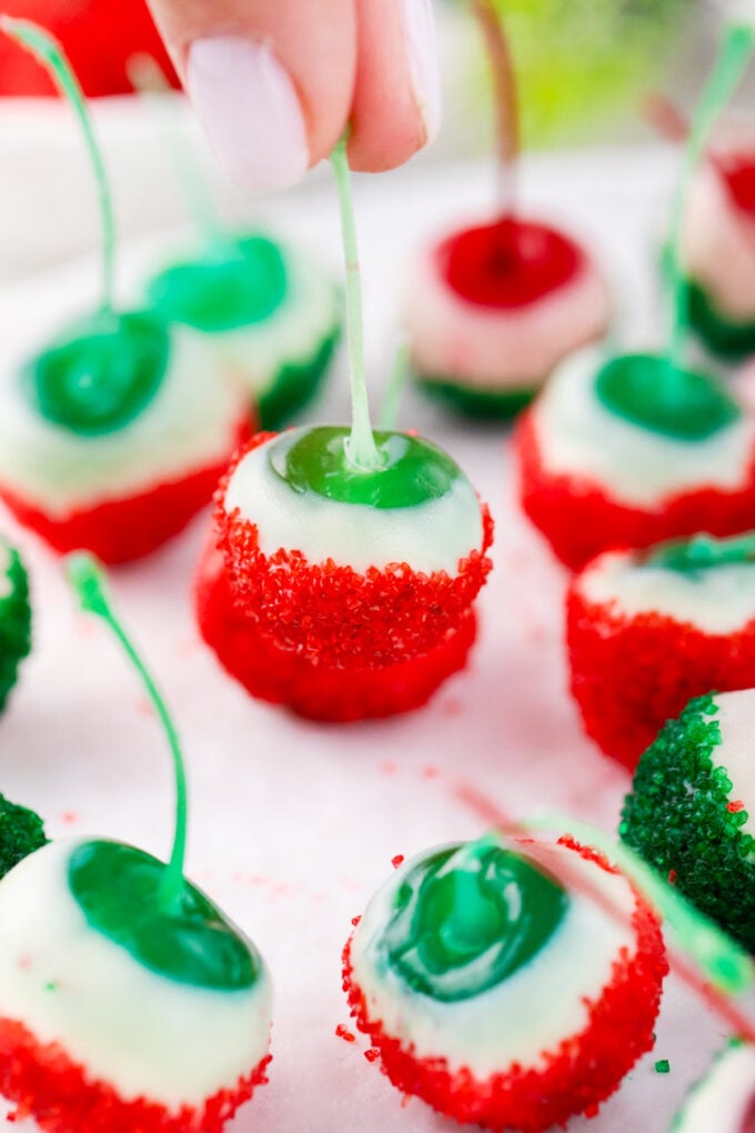 Christmas drunken cherries dipped in white chocolate, red and green sanding sugar.