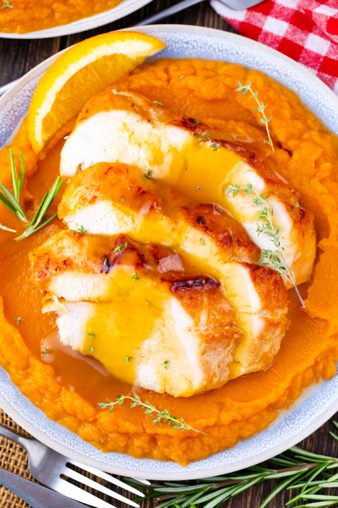 Oven roasted turkey breast with honey orange sauce over sweet mashed potatoes.