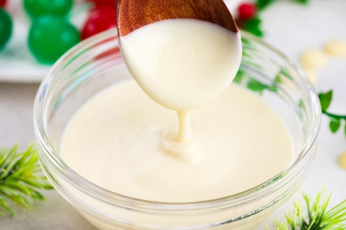 Melted white chocolate dripping of a spoon.
