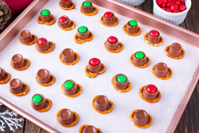 Rudolph noses from pretzels, Rolos, and M&M's on a baking sheet.
