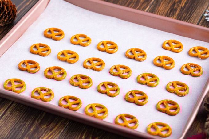 Arranging pretzels on a cookie sheet.