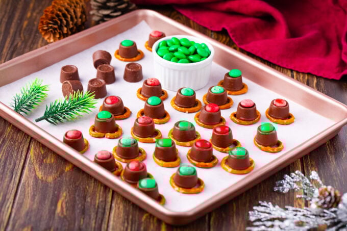 Reindeer noses from pretzels, Rolos, and M&M's on a cookie sheet.