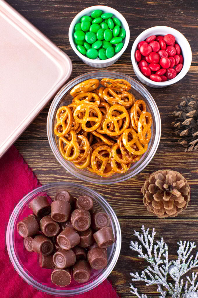Rudolph noses ingredients in bowls on a wooden table.