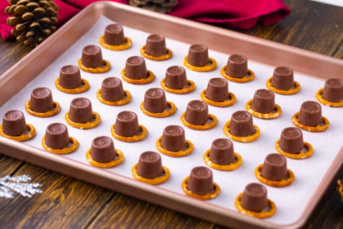 Pretzels topped with Rolos on a cookie sheet,