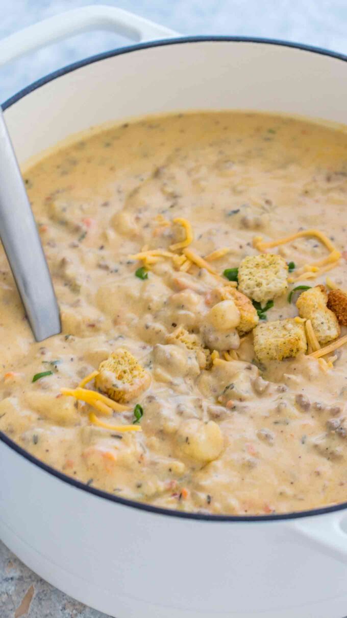 Cheesy cheeseburger soup in a Dutch oven.