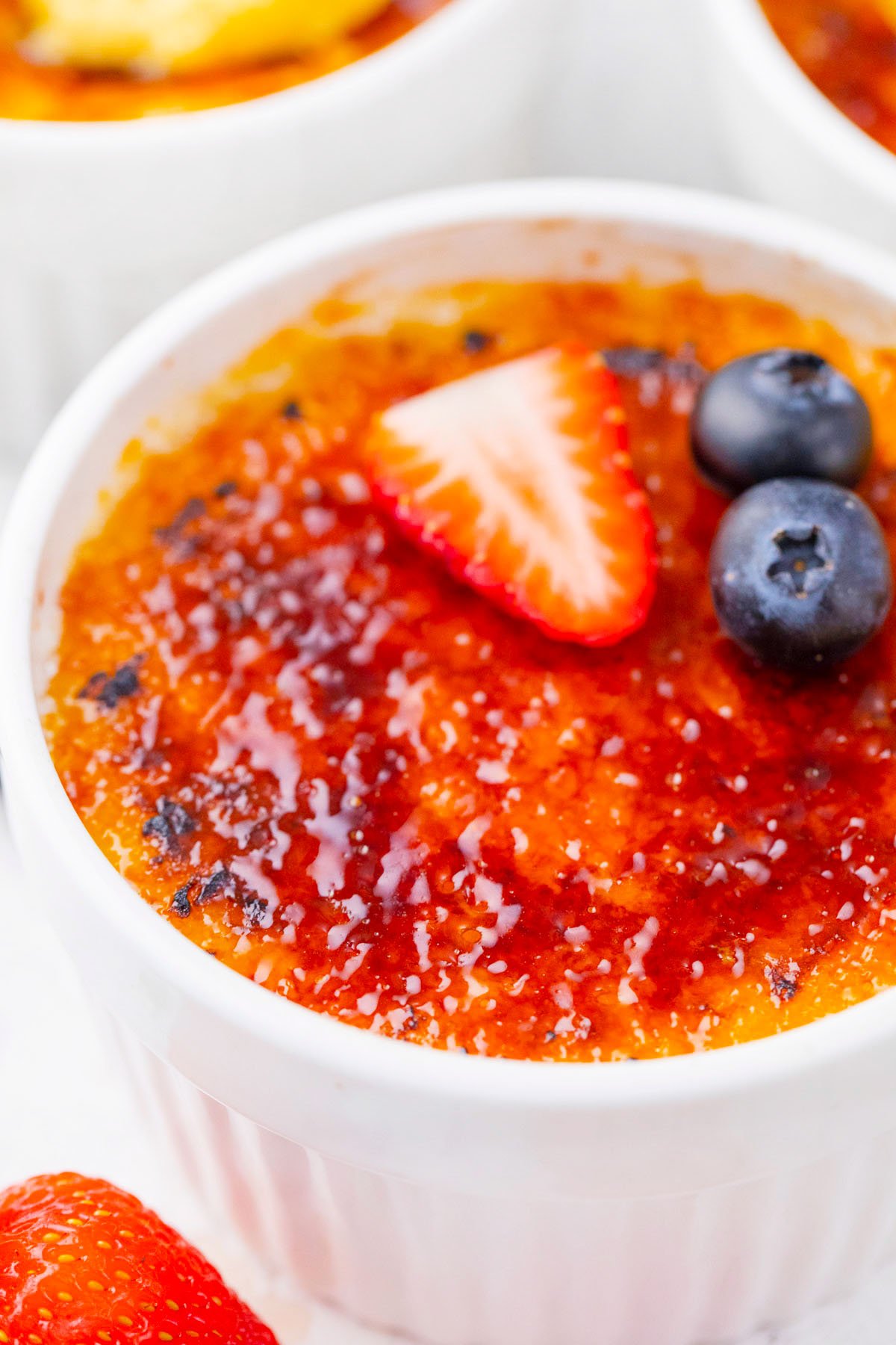 Creme brulee topped with berries.