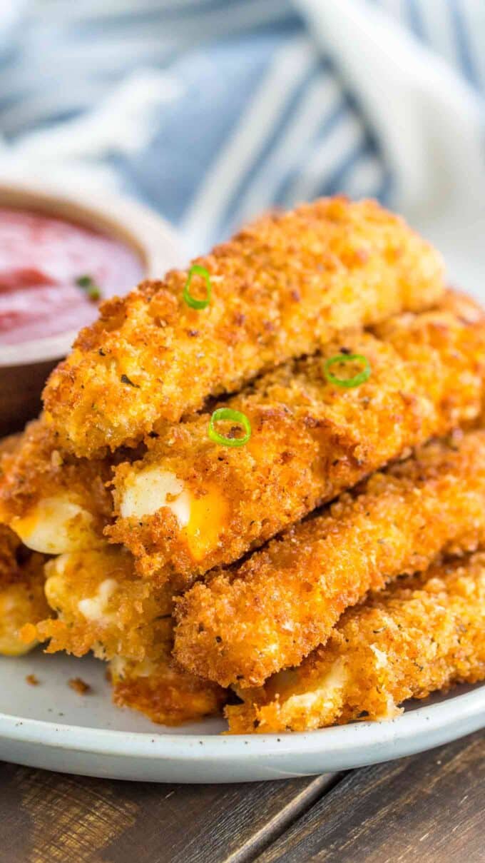 Mozzarella cheese sticks on a white plate 