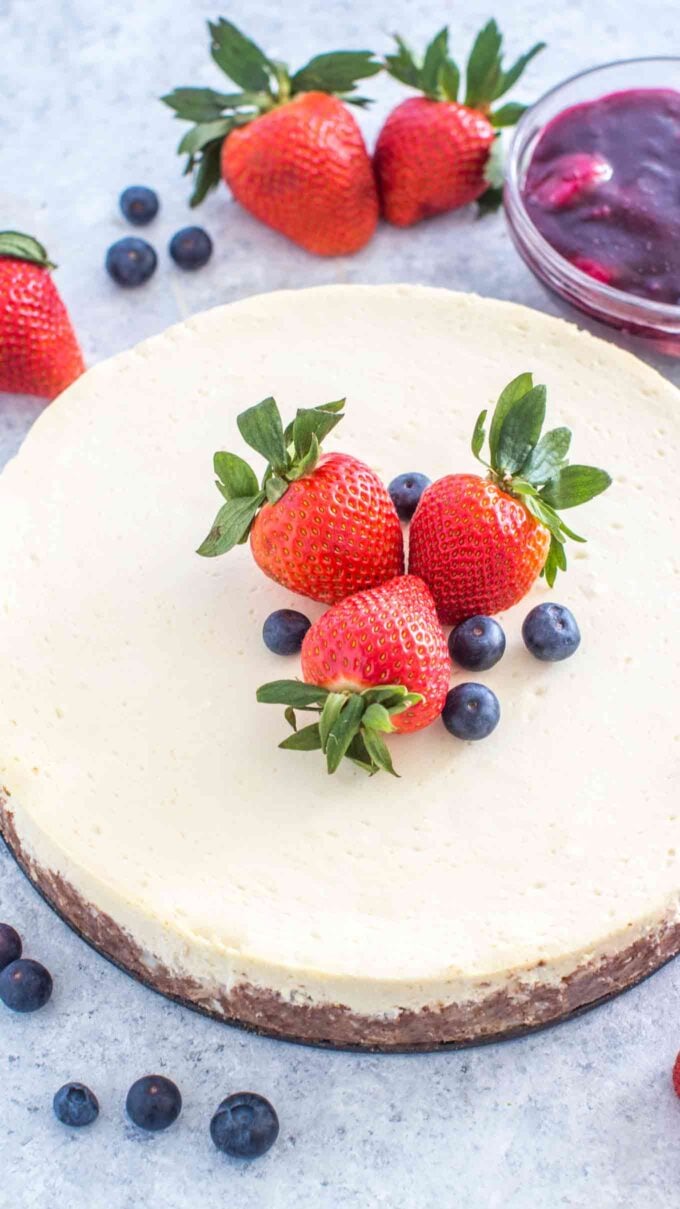 keto cheesecake topped with strawberries and blueberries