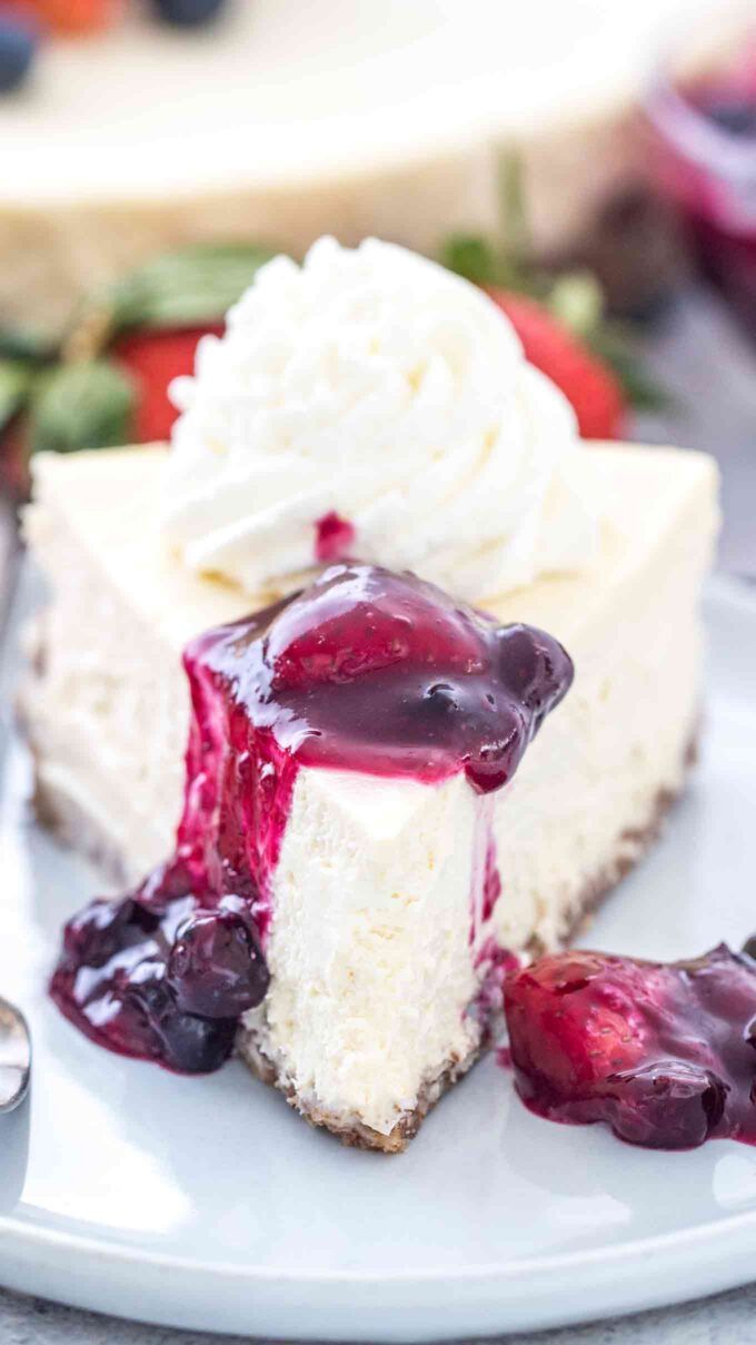 Keto cheesecake topped with whipped cream and strawberry jam. 