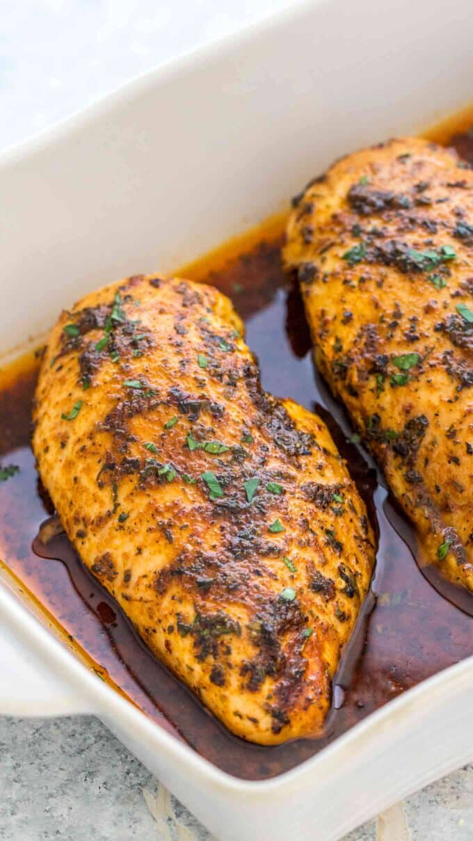 Juicy oven baked chicken breasts in a baking tray 