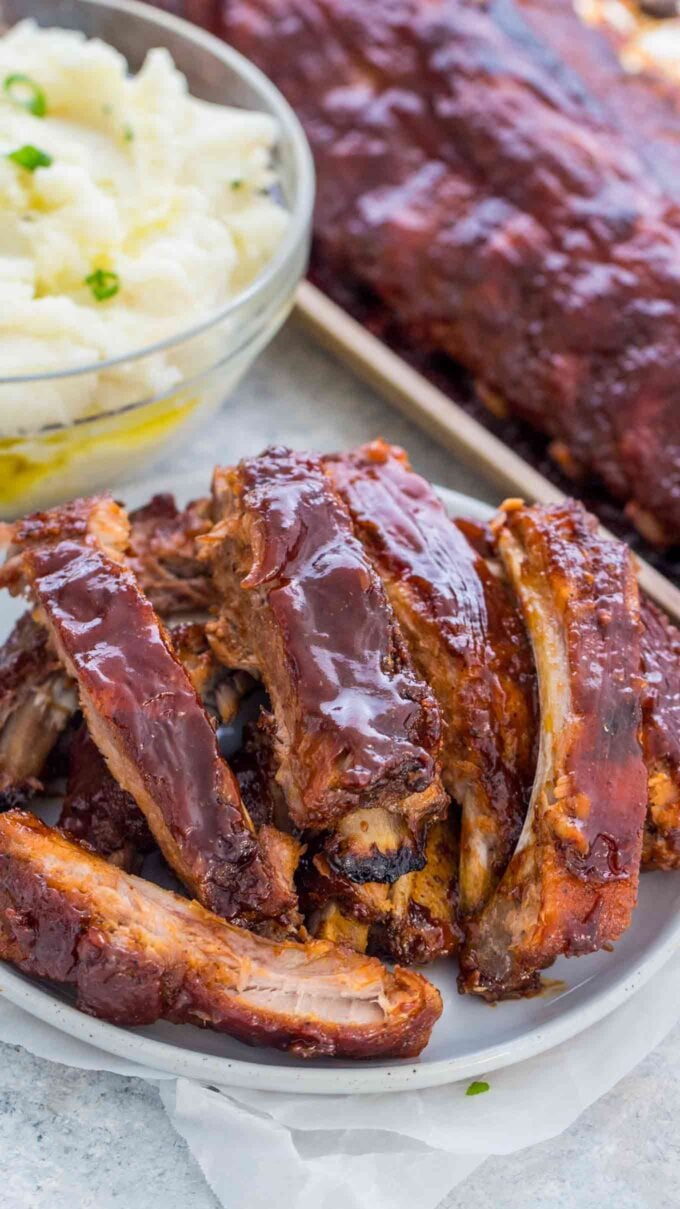 Photo of oven barbecue ribs on a white plate.