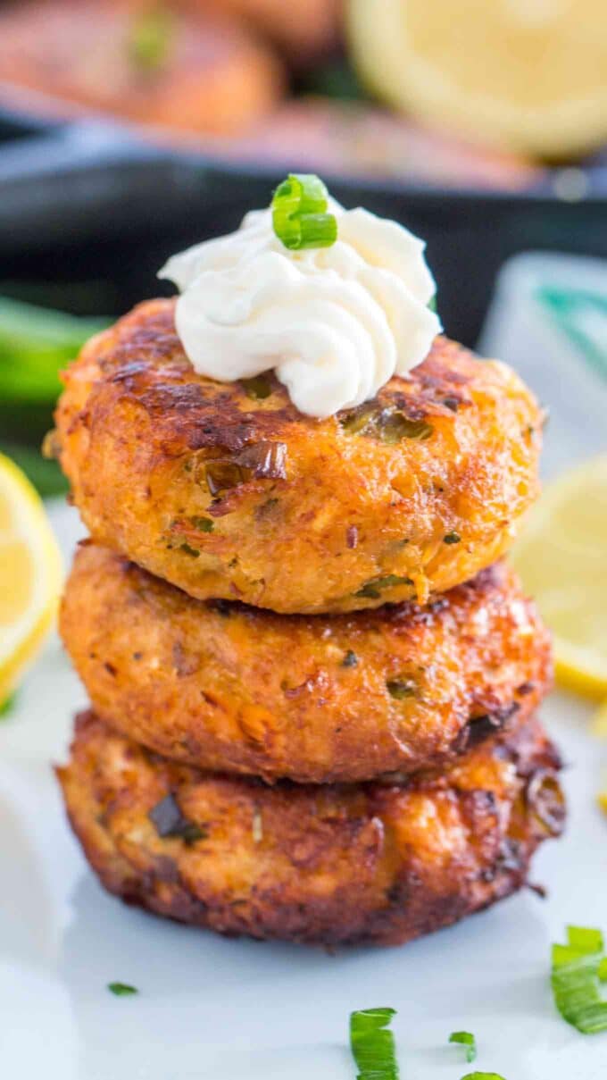 Picture of salmon patties garnished with mayo.