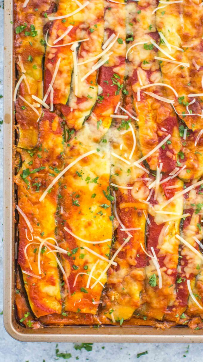 Zucchini Lasagna with tomato sauce and topped with shredded cheese in a large casserole dish