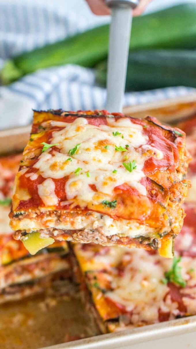 A slice of cheesy zucchini lasagna on a spatula 