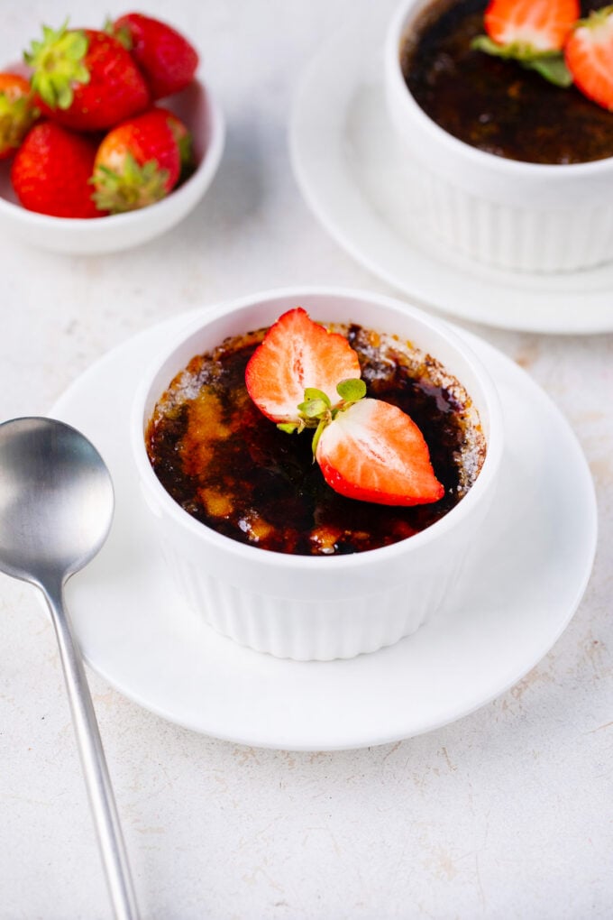 Homemade chocolate creme brulee topped with strawberries.
