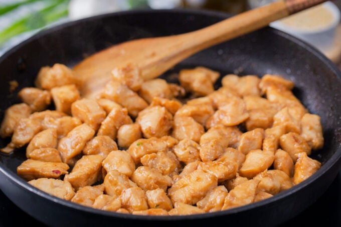 Cooking chicken pieces in the pan.