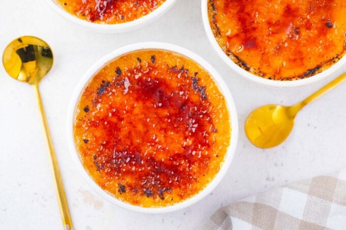 Overhead shot of ramekins with creme brulee.