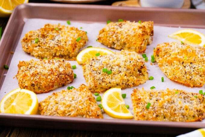 Crispy oven baked tilapia on a baking sheet.