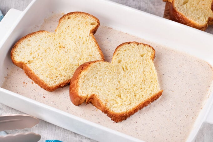 Soaking brioche slices in an egg and cream mixture.