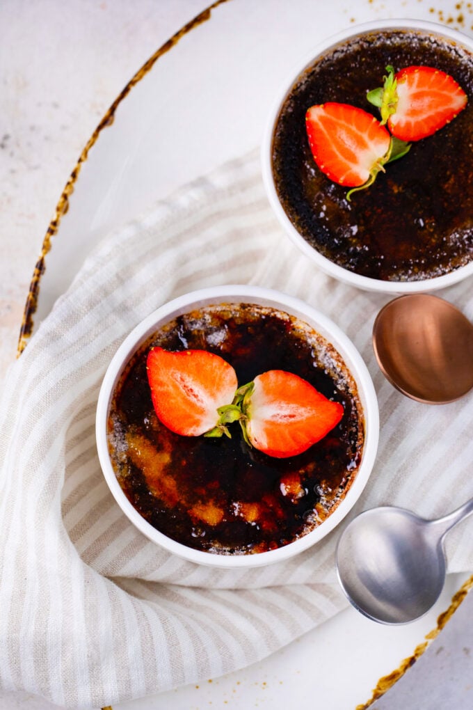 Overhead shot of chocolate creme brulee topped with strawberries.