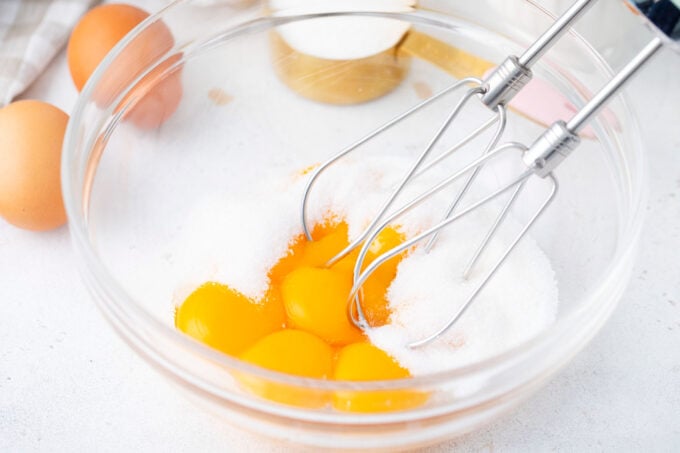 Whisking egg yolks and sugar.