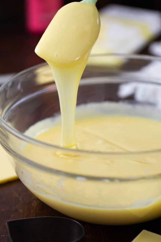 melted white chocolate and condensed milk dripping of a spatula