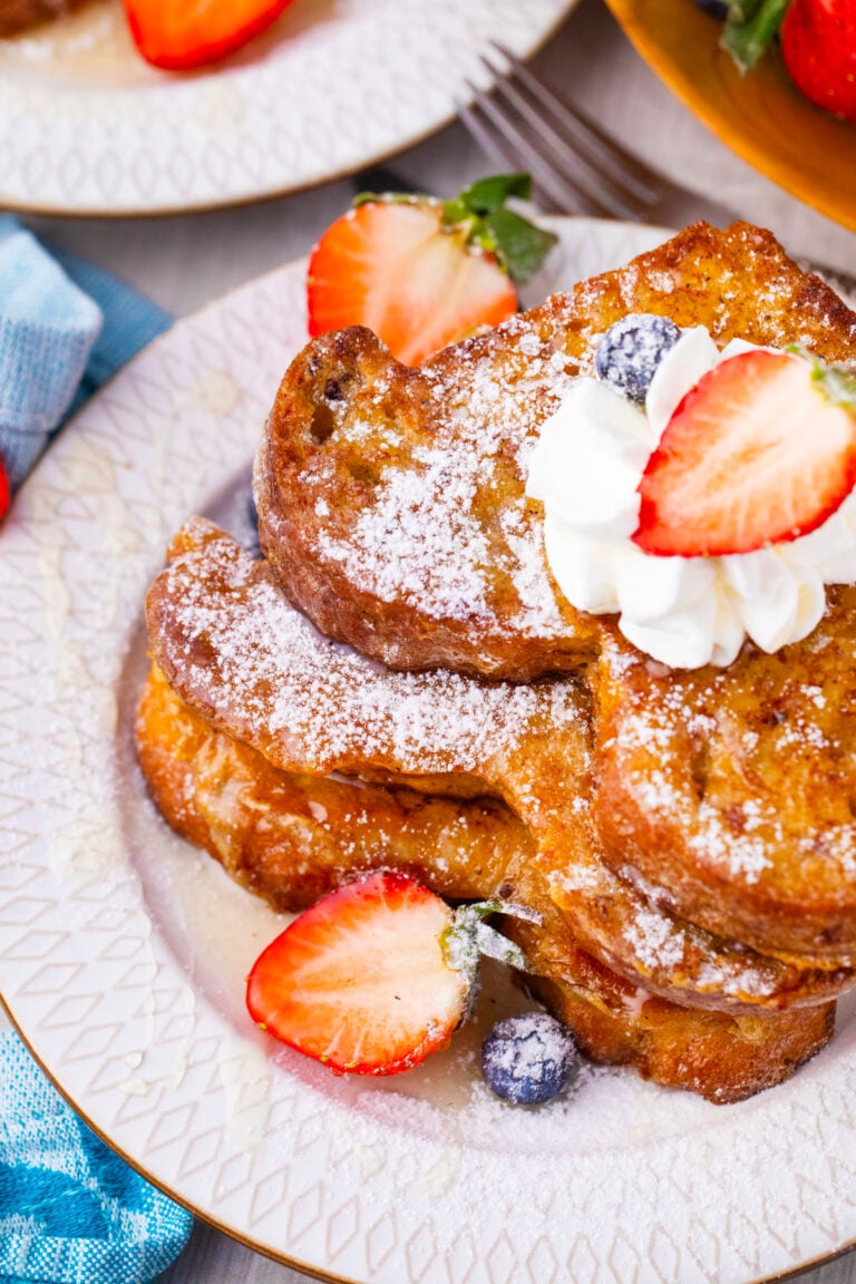 Homemade brioche French toast served with berries and whipped cream.