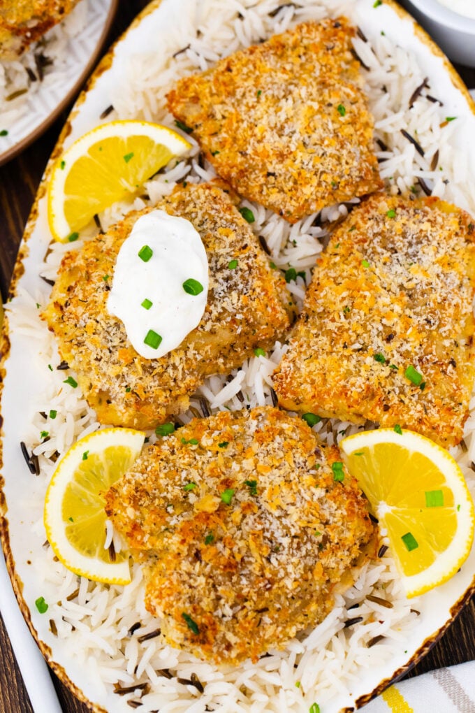 Overhead shot of crispy oven baked tilapia topped with lemon aioli.