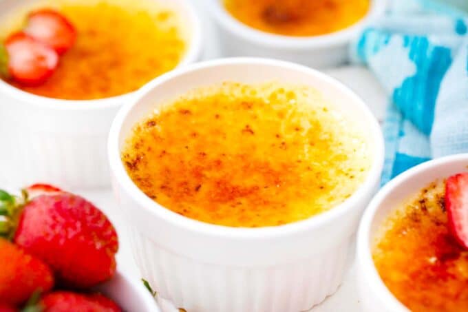 white chocolate creme brulee served with fresh strawberries