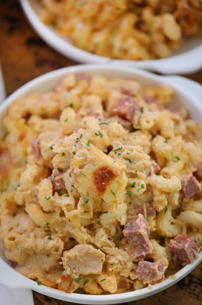 Cheesy chicken cordon blue casserole in a white bowl