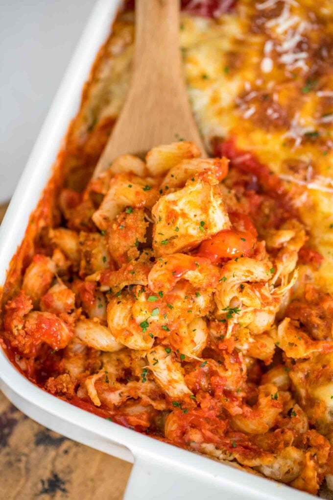 Creamy chicken parmesan casserole with pasta on a baking dish