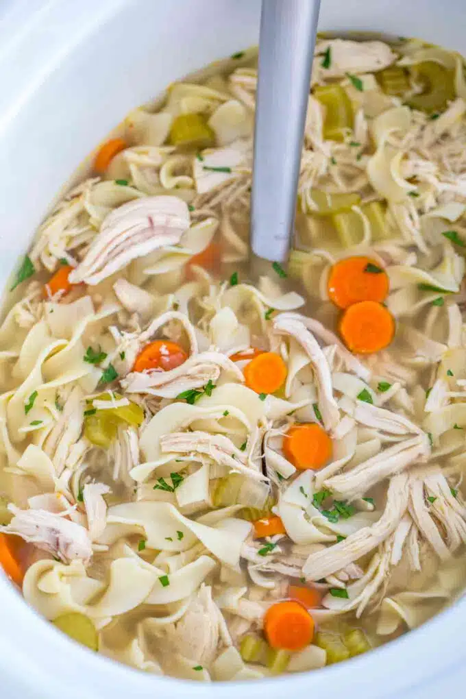Homemade chicken noodle soup with veggies in the crock pot