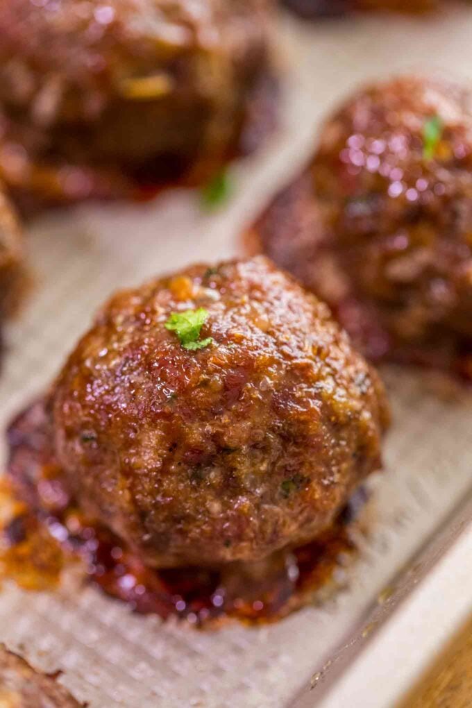 Cooked meatballs made of ground beef and ground pork on a baking sheet