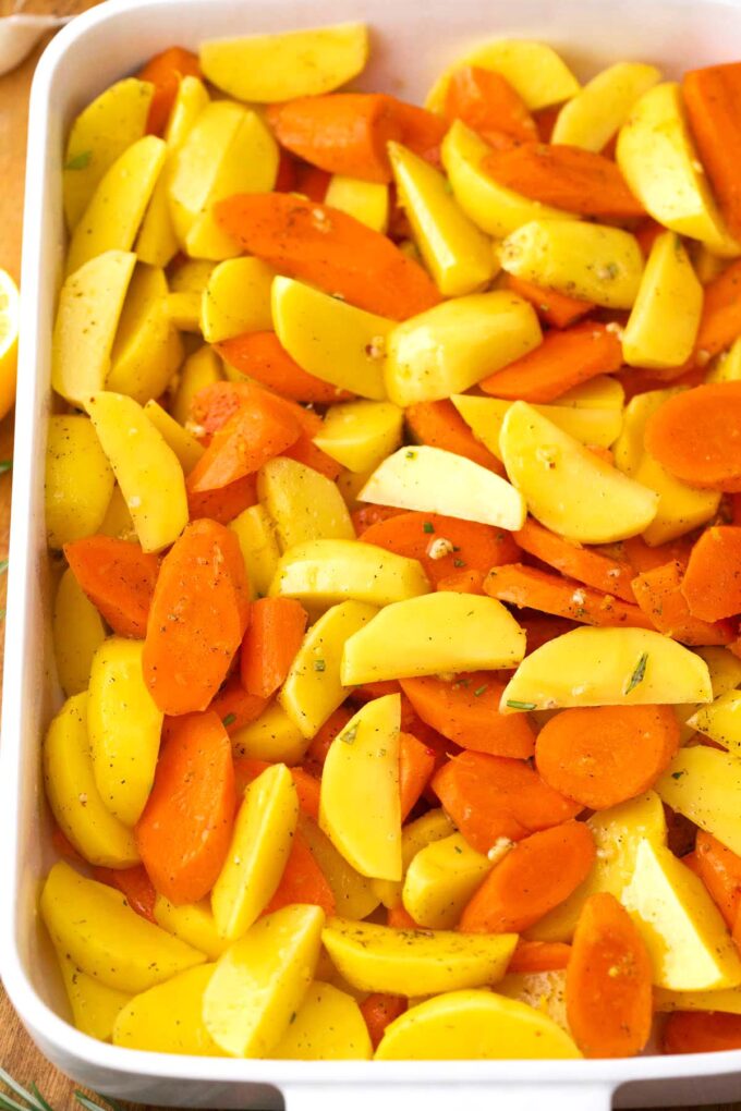 Chopped carrots and potatoes in a baking dish.