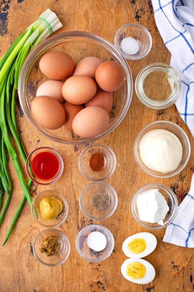 deviled eggs ingredients in bowls on a table