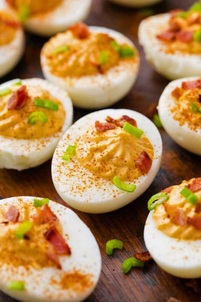 deviled eggs with bacon, chopped green onions, and paprika