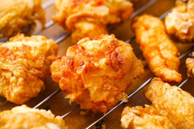 Crunchy homemade fried chicken pieces on a wire rack.