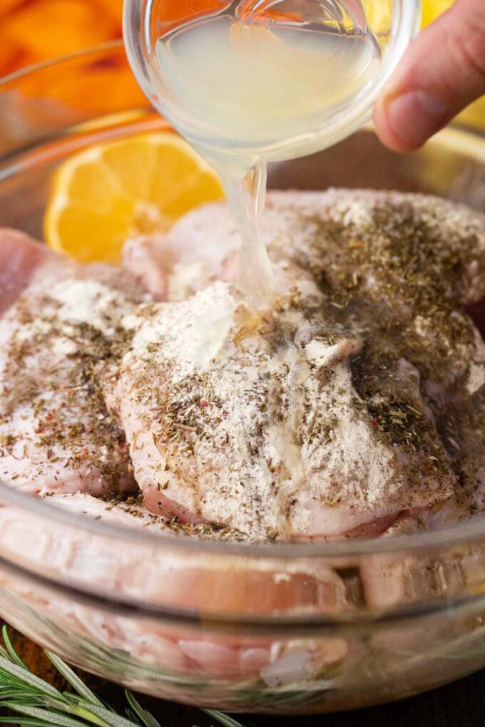 Marinating chicken thighs in a bowl.