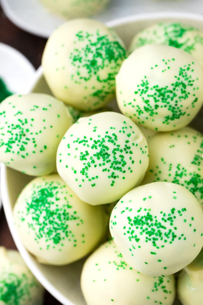 A bowl of mint chocolate chip truffles topped with green sanding sugar.