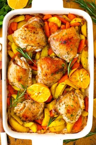 Overhead shot of perfectly golden-brown Italian chicken and potatoes in a roasting pan.