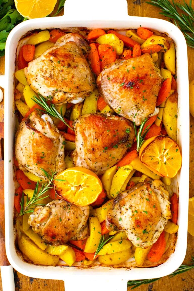 Overhead shot of perfectly golden-brown Italian chicken and potatoes in a roasting pan.