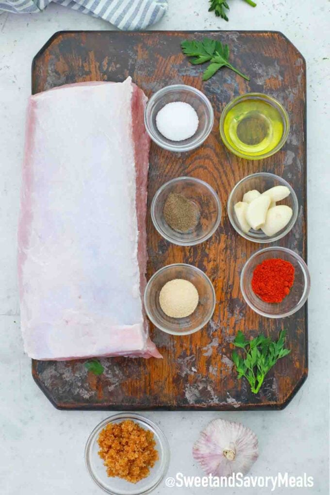 raw pork loin and seasonings on a cutting board