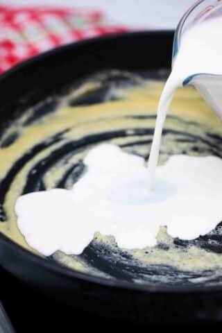 adding cream to make a roux in a skillet