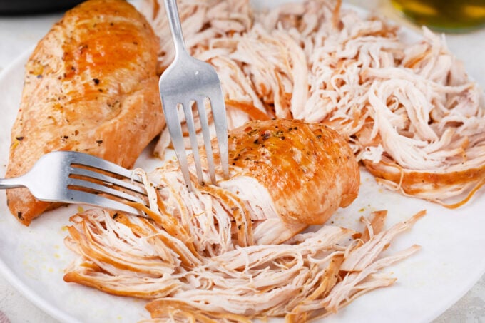 Shredding chicken breasts.
