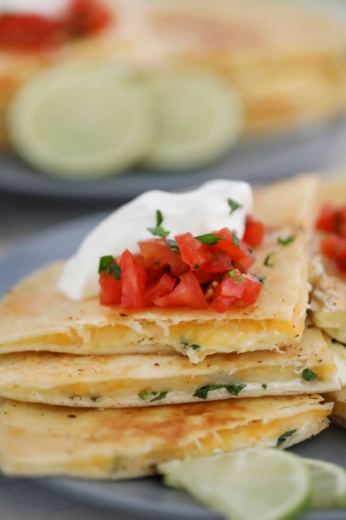 Easy cheese quesadilla topped with salsa and sour cream 